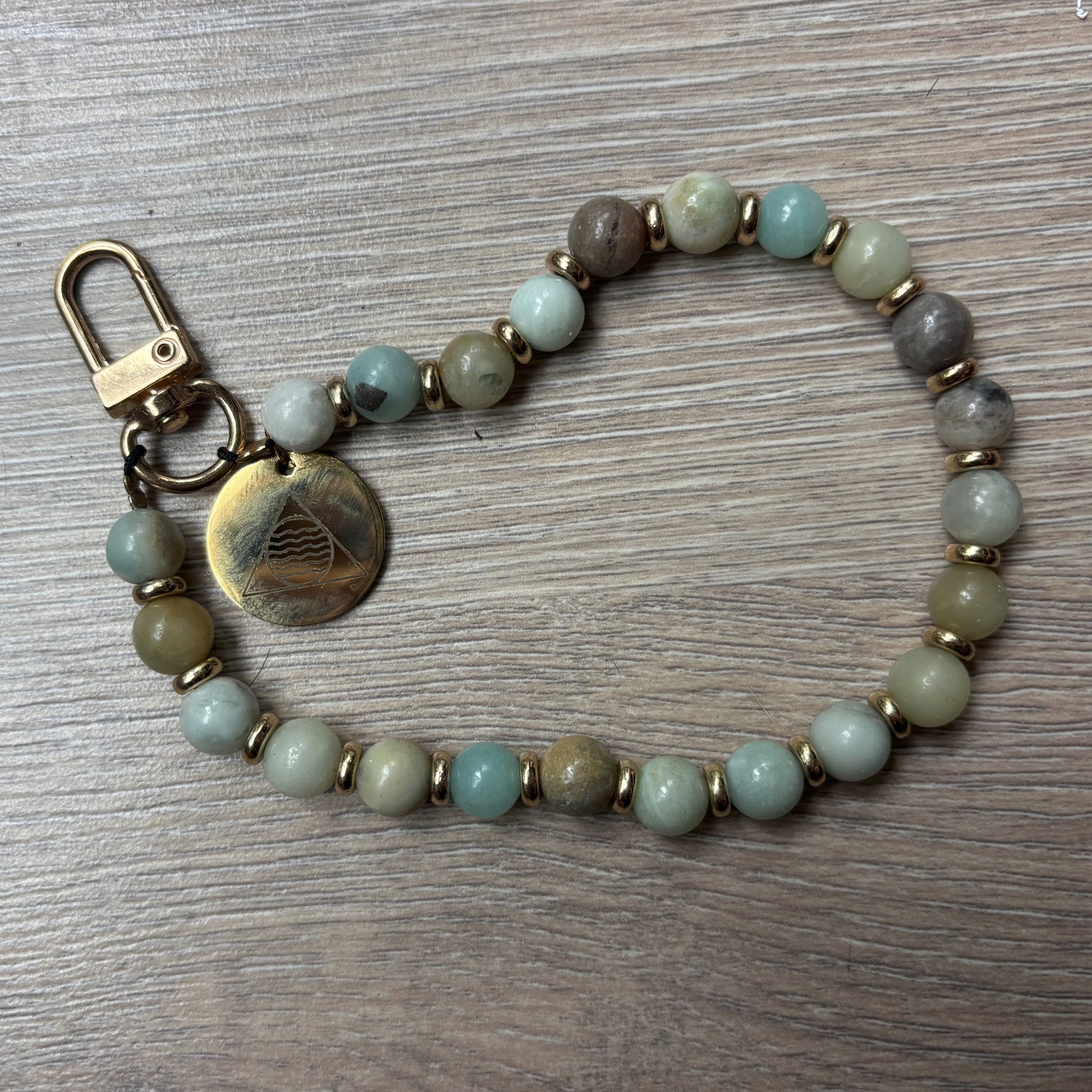 Beaded keychain with a metal clasp on a wooden surface